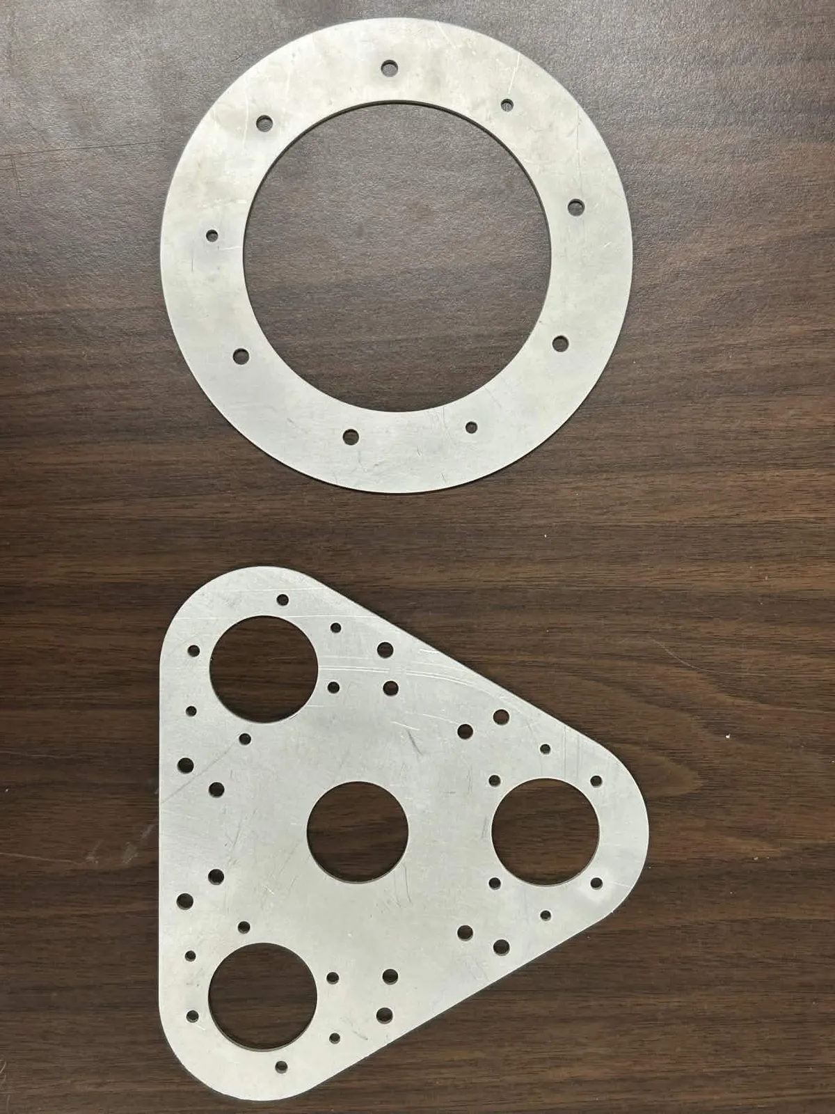 Aluminum gearbox plates freshly cut on the water jet